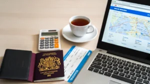 Flat lay with passport, calculator, laptop and boarding pass illustrating how to calculate Avios points for flights