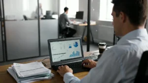 UK small business owner reviewing invoices and cash flow documents in GBP while using invoice financing.